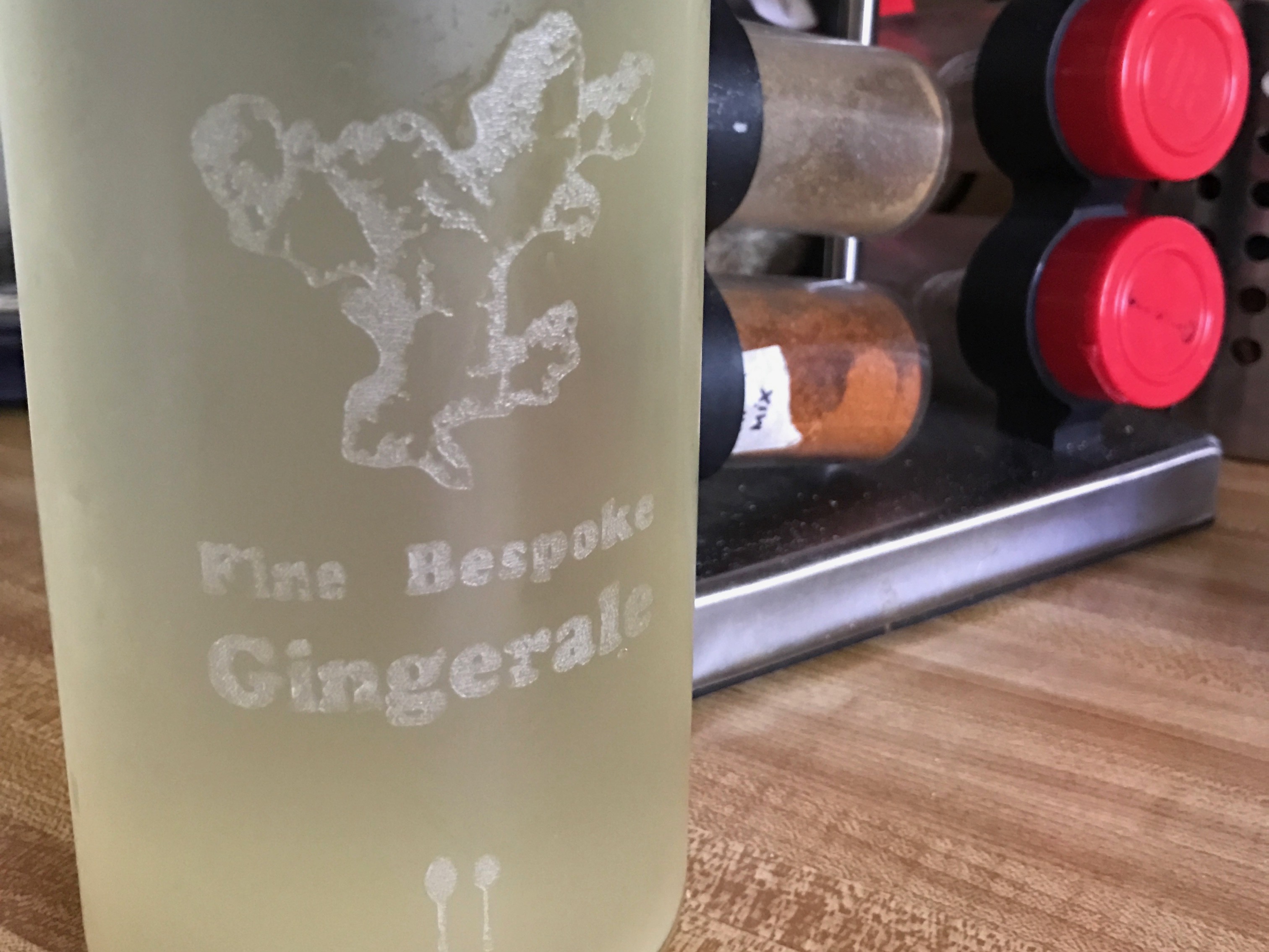 A full bottle laser-etched with a ginger plant and the words "Fine Bespoke Gingerale".