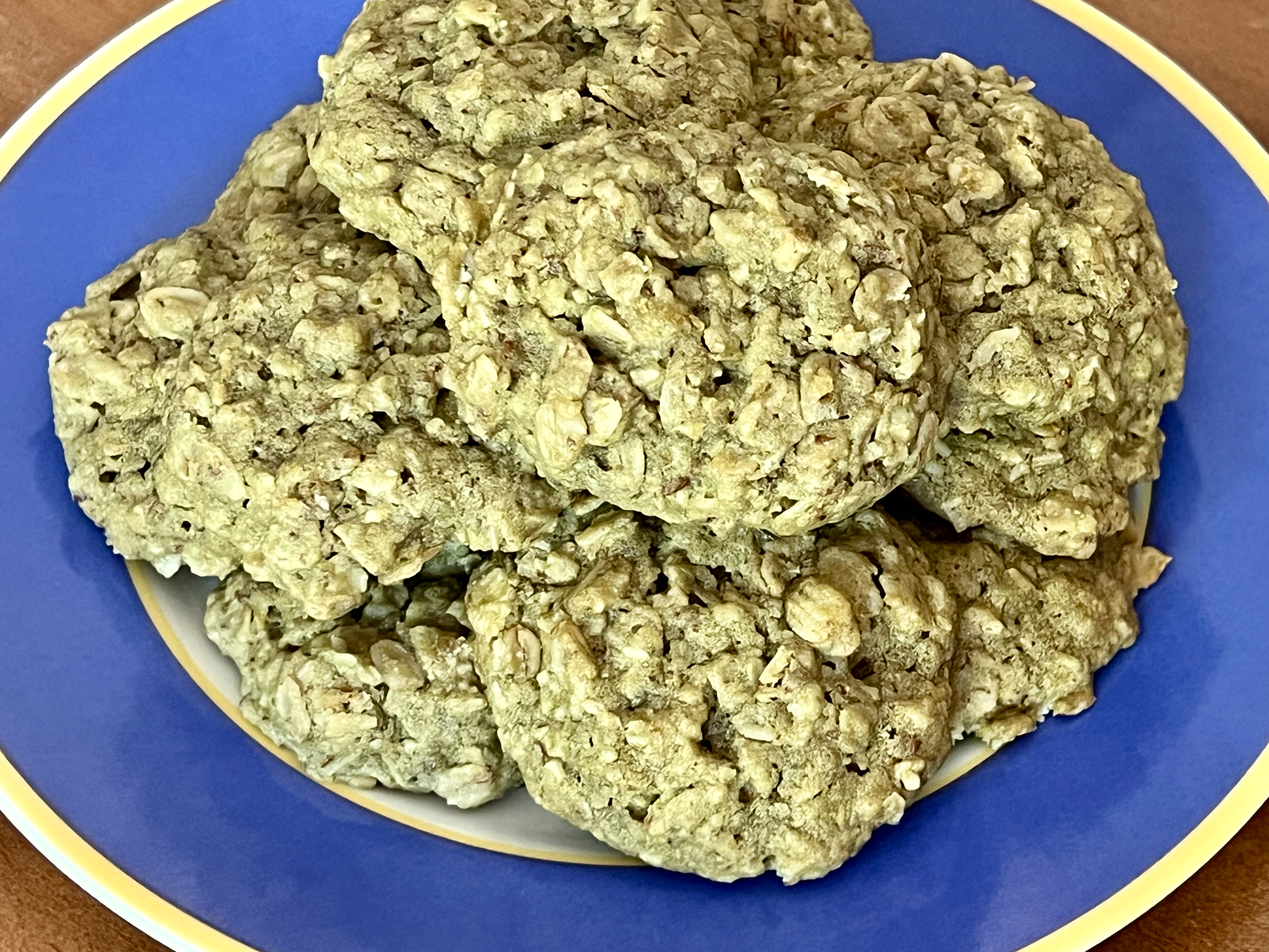 A plate of slightly green oatmeal cookies.