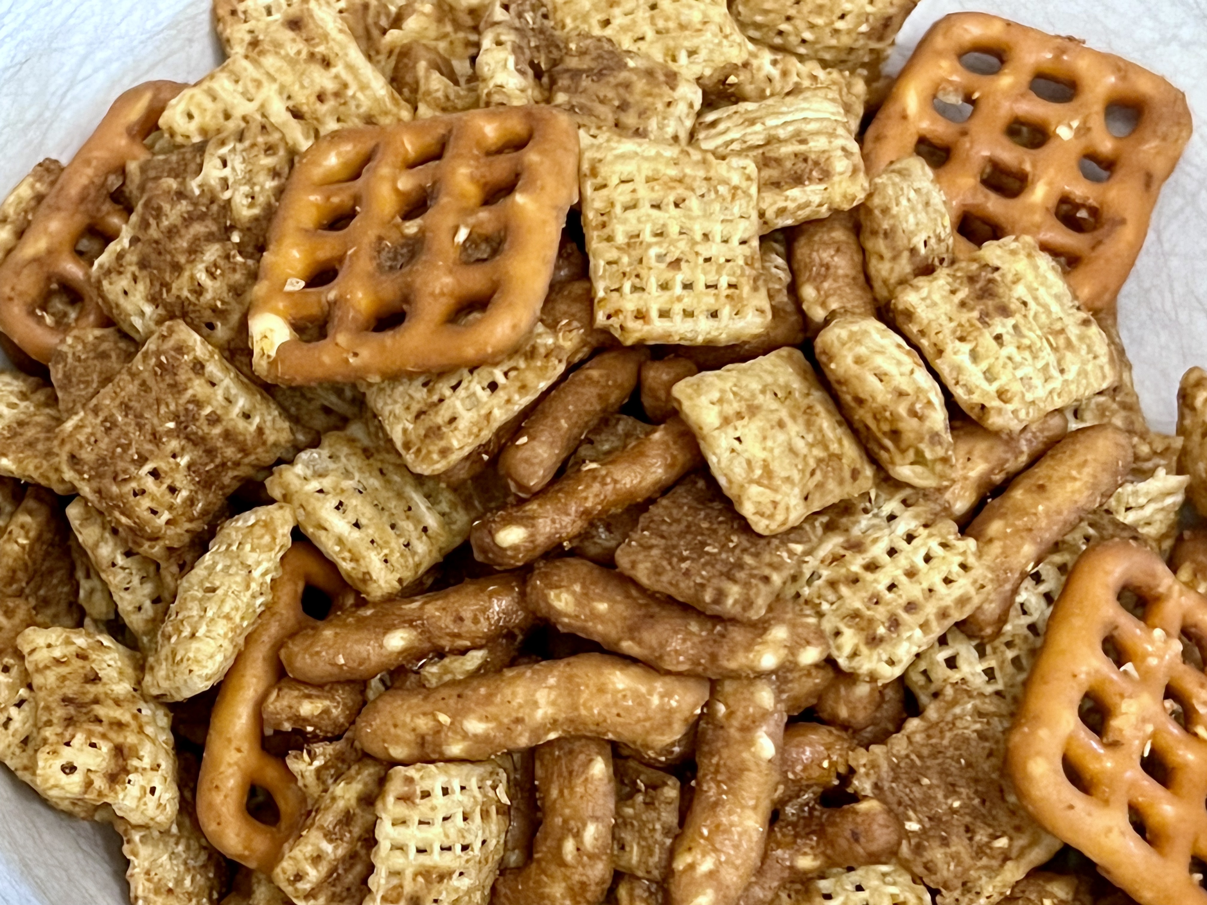 Flavored Chex with square-shared hard pretzels and sesame sticks.
